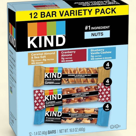 Box of KIND bars with various flavors on a beige background