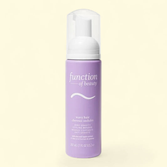 Purple bottle of 'function of beauty' on a beige background