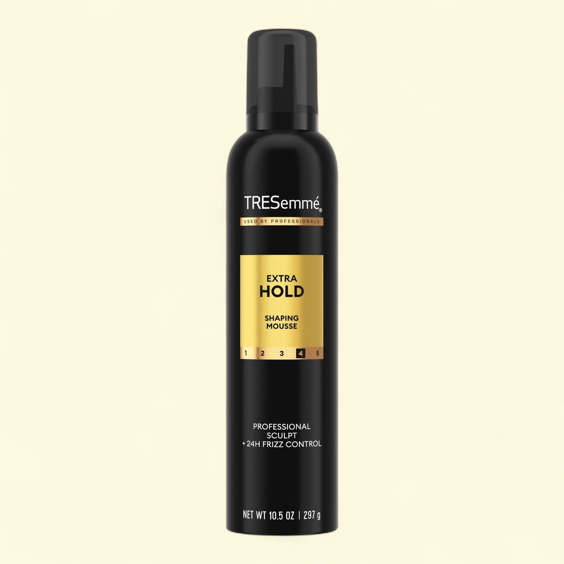TRESemmé Extra Hold Shaping Mousse bottle on a black background