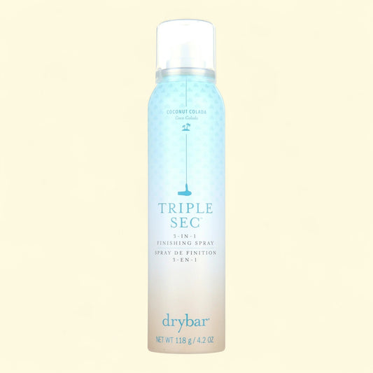 Drybar Triple Sec 3-in-1 Finishing Spray bottle on a light beige background