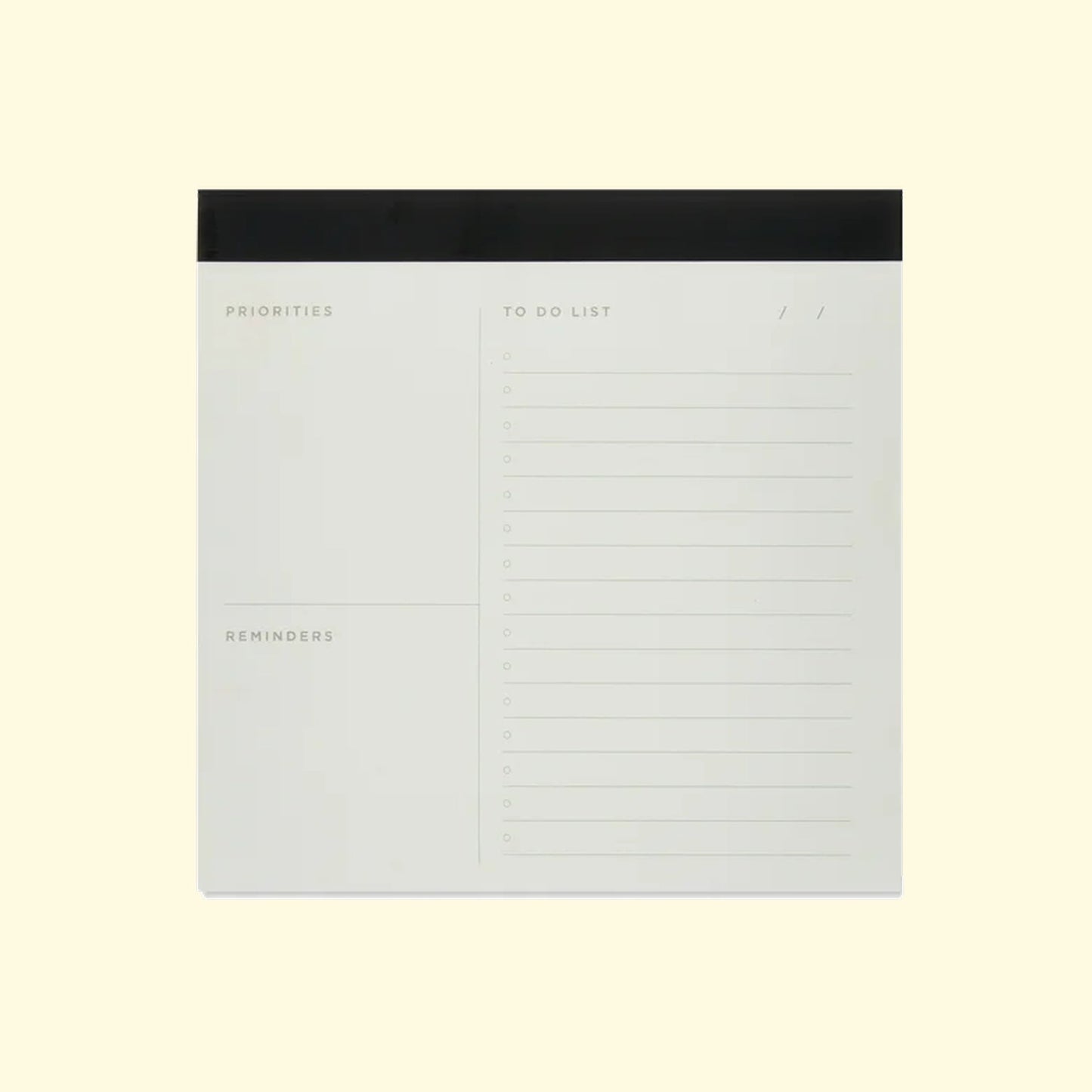 Notebook with sections for priorities, to-do list, and reminders on a light