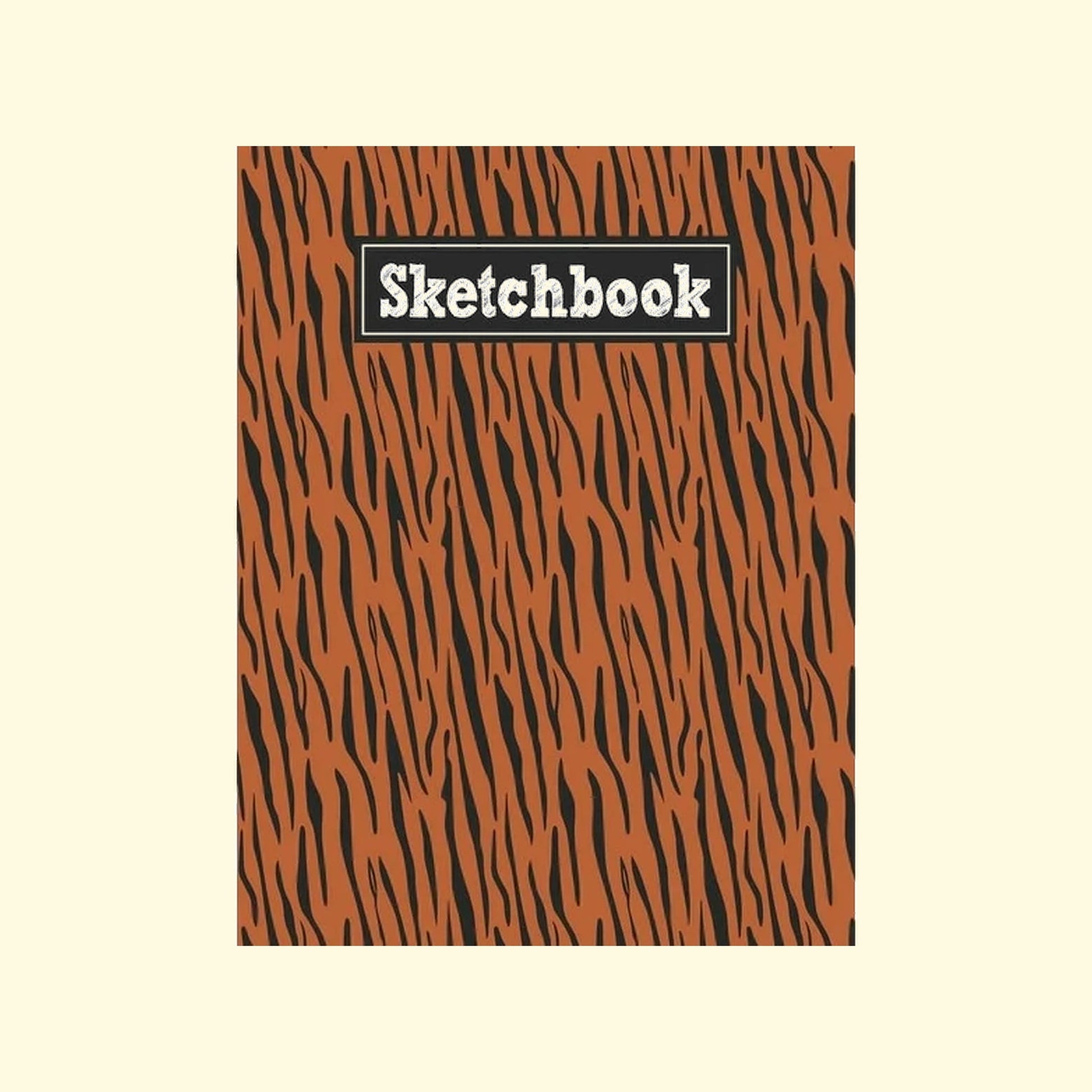 Sketchbook with orange and black zebra pattern on a beige background