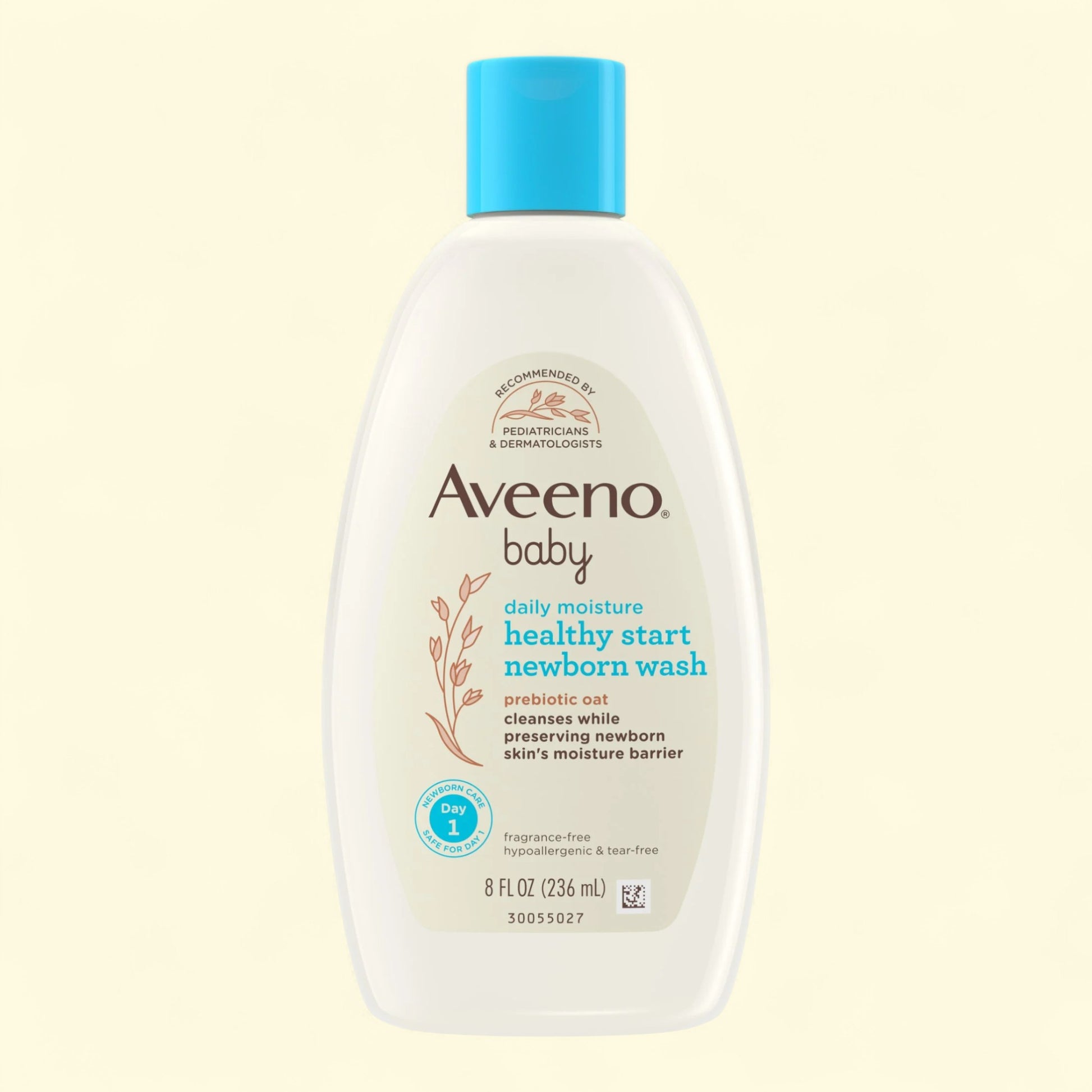 Aveeno baby healthy start newborn wash bottle on a beige background
