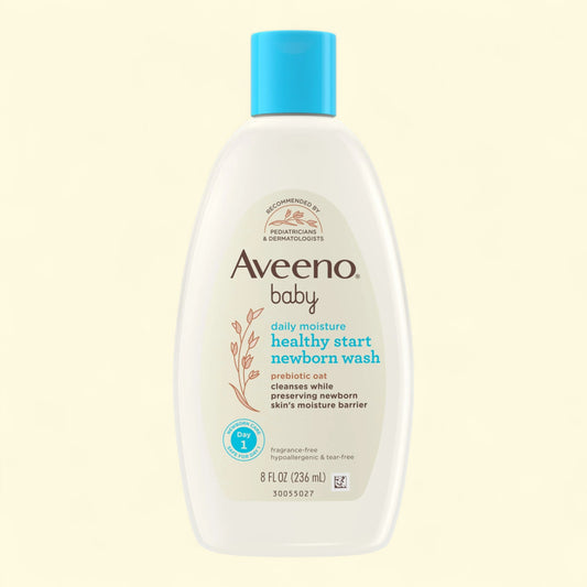 Aveeno baby healthy start newborn wash bottle on a beige background
