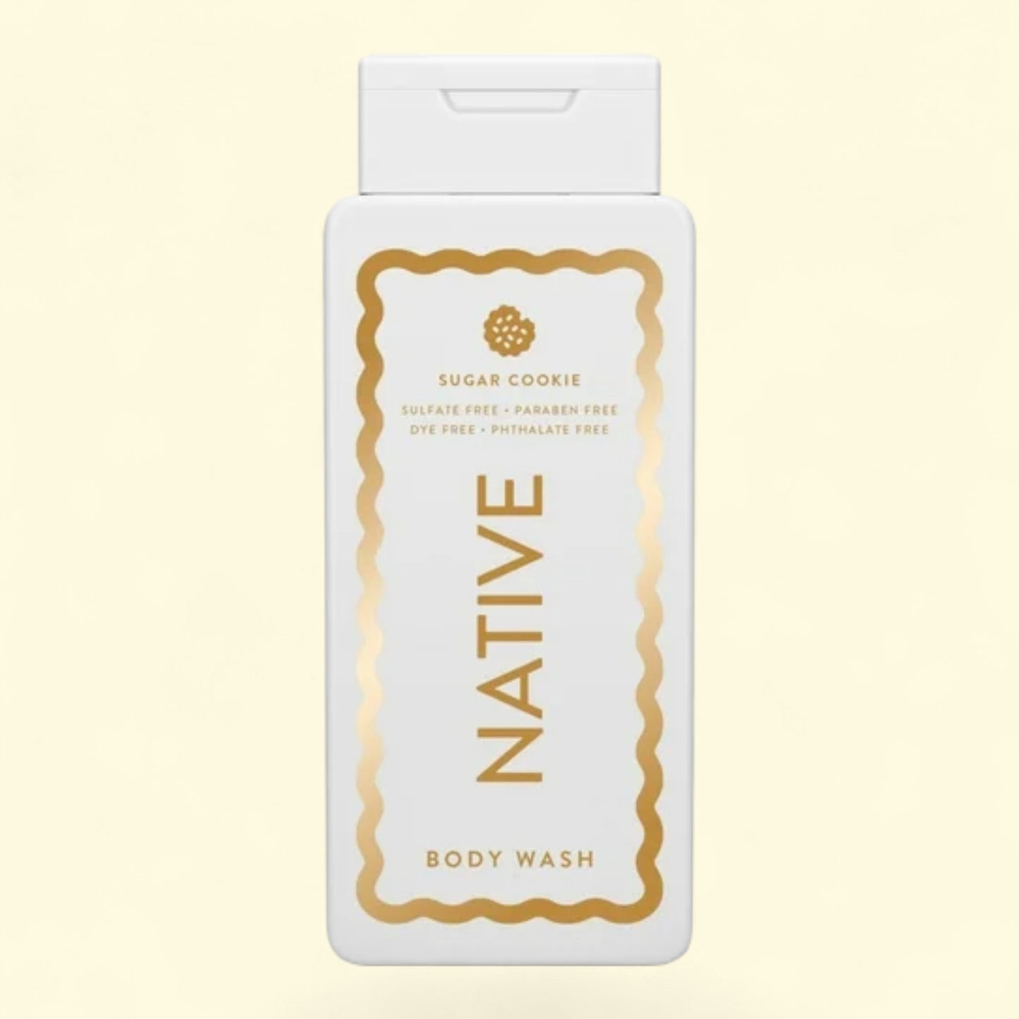 Native body wash bottle with gold text on a light beige background