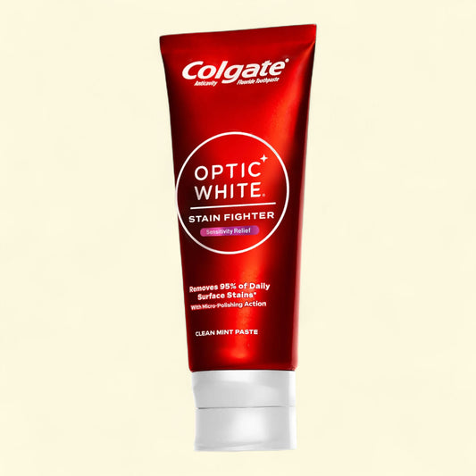 Colgate Optic White toothpaste tube on a beige background