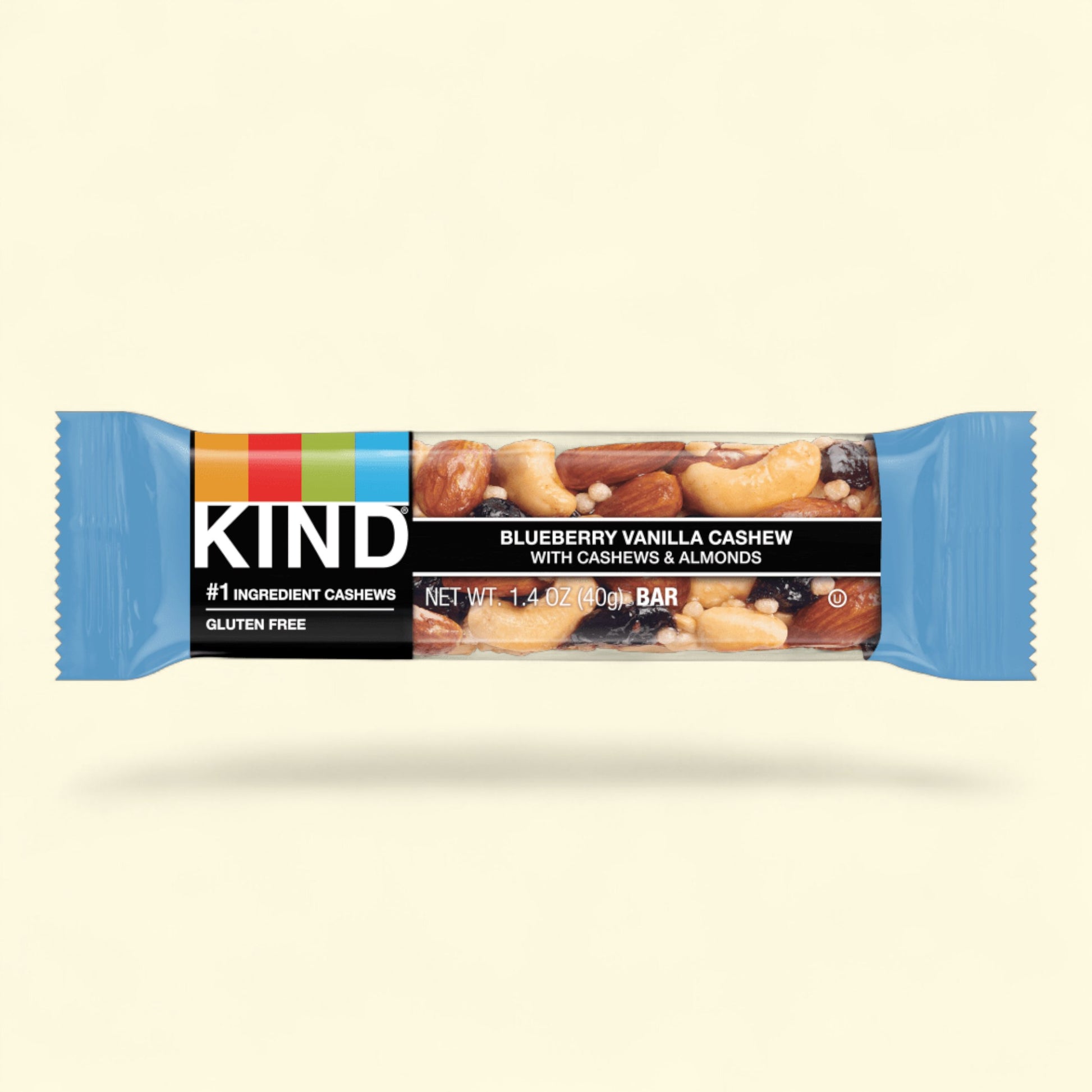 Kind Blueberry Vanilla Cashew bar on a beige background