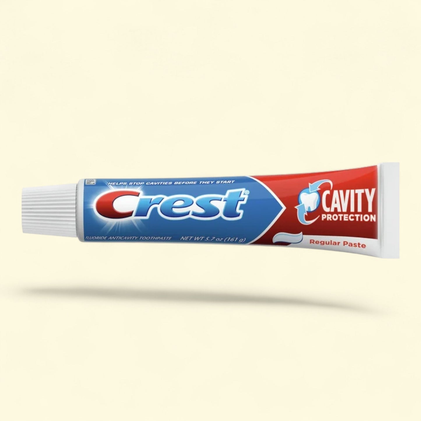 Tube of Crest cavity protection toothpaste on a beige background