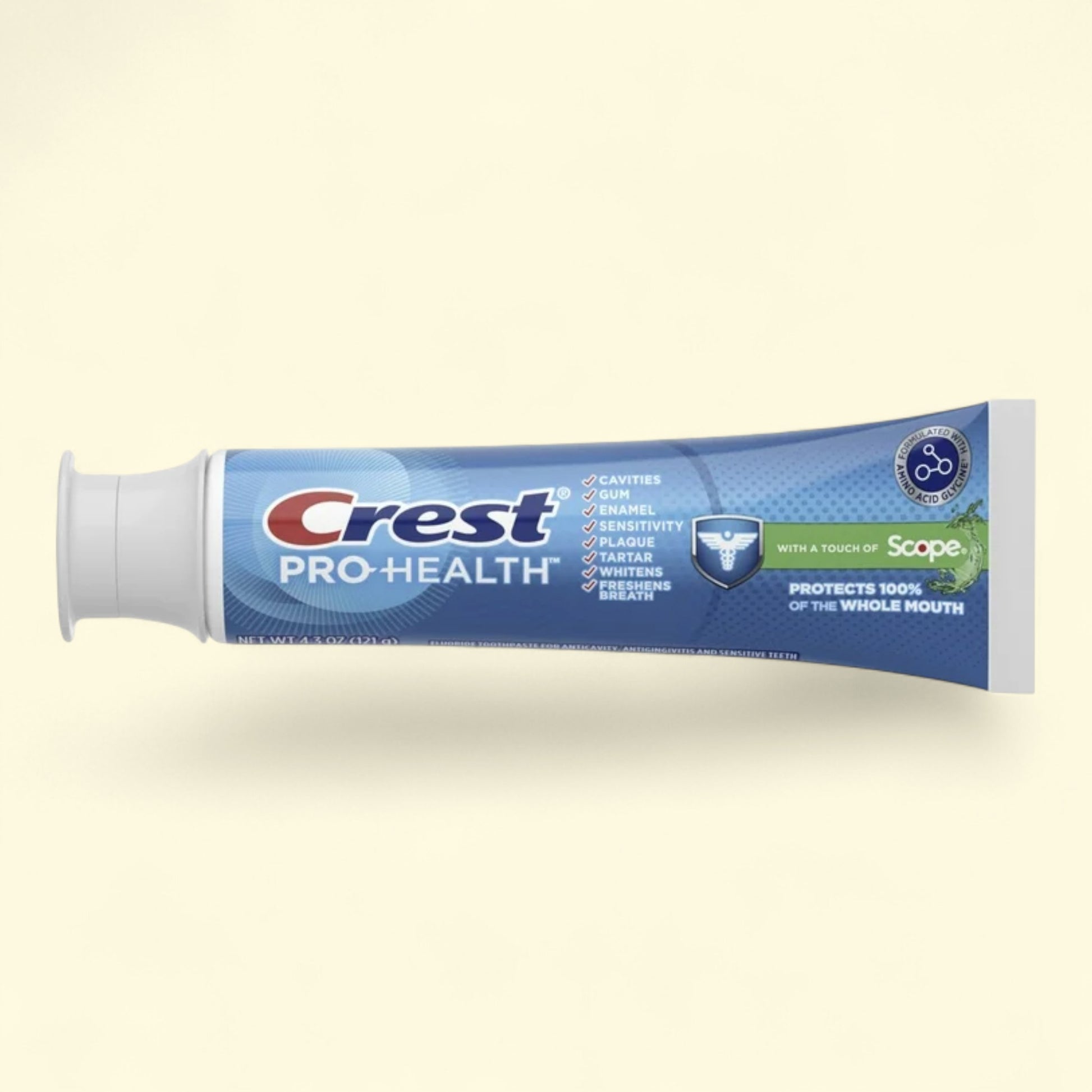 Crest Pro-Health toothpaste tube on a beige background