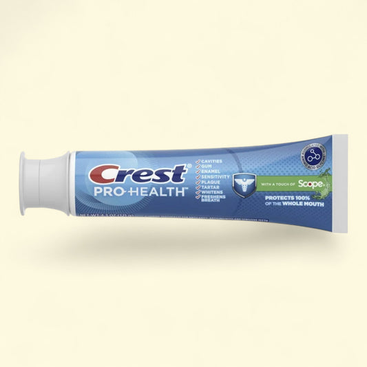 Crest Pro-Health toothpaste tube on a beige background