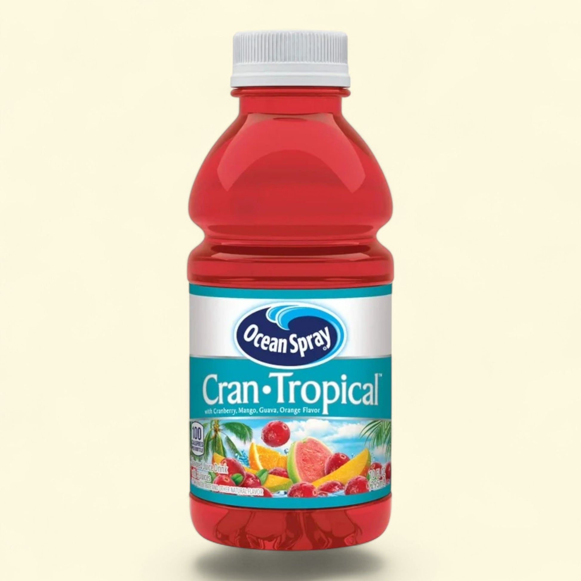 Red bottle of Ocean Spray Cran-Tropical juice on a beige background