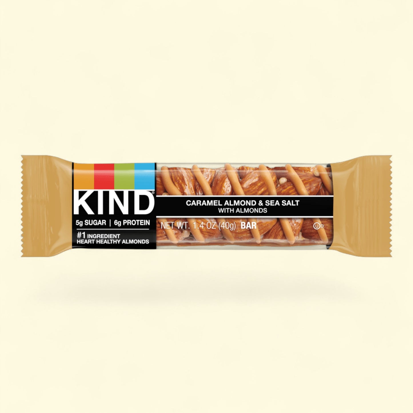 Kind bar with caramel almond and sea salt flavor on a beige background