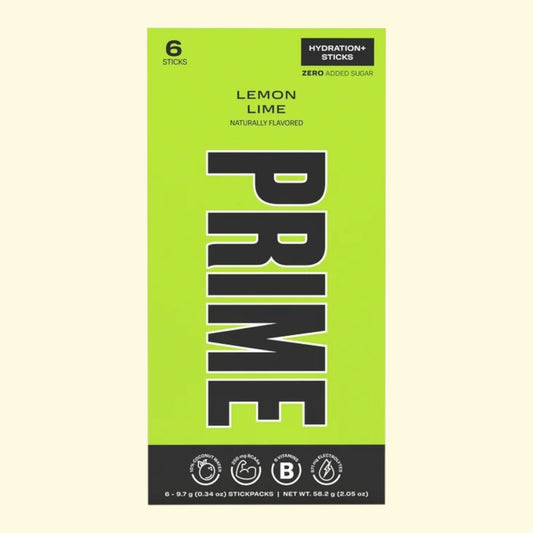 Green packaging of Prime Lemon Lime hydration sticks on a beige background
