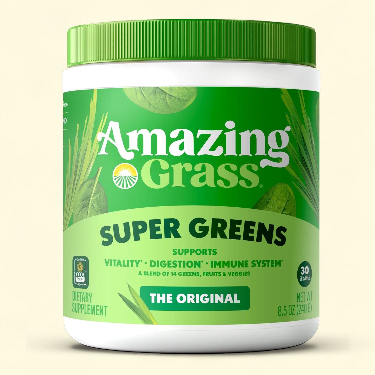 Container of Amazing Grass Super Greens supplement on a beige background