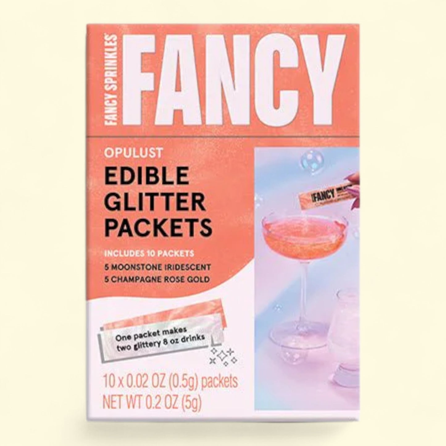 Box of Fancy Sprinkles Edible Glitter Packets on a light pink background