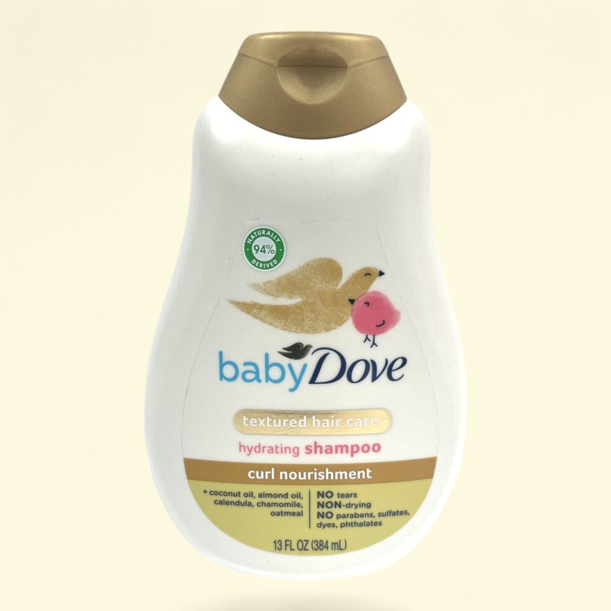 Baby Dove shampoo bottle on a beige background