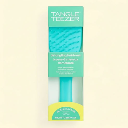 Treatspree Essential Detangler hairbrush in turquoise green, designed for hair prone to breakage.