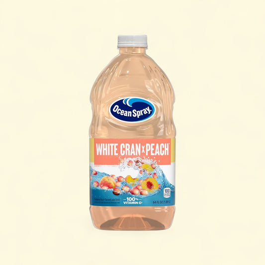 Treatspree Ocean Spray White Cran-Peach Juice Drink 64 fl oz bottle with real cranberries and peaches splashing in water.