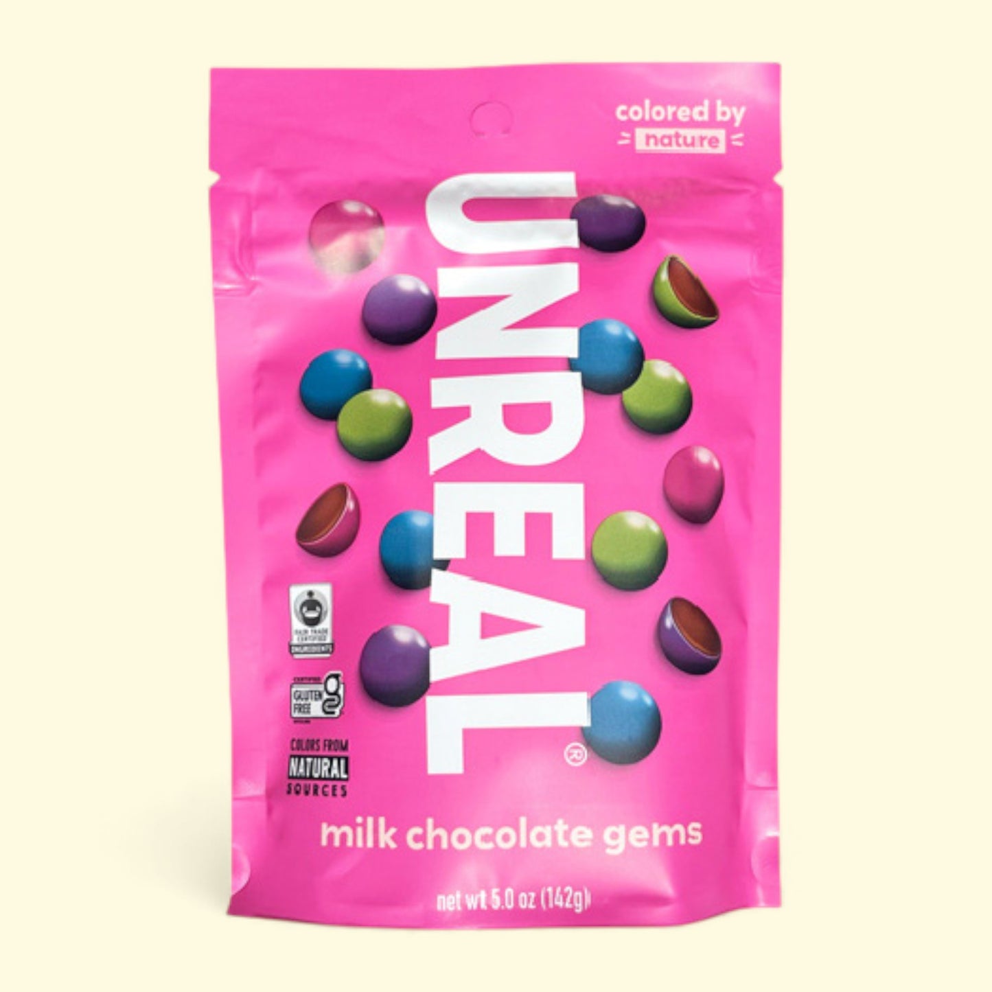Pink package of Unreal milk chocolate gems on a white background