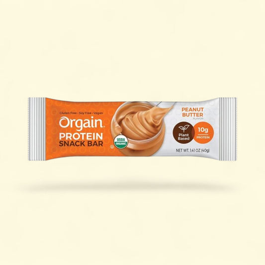Orgain Peanut Butter protein snack bar packaging on a beige background